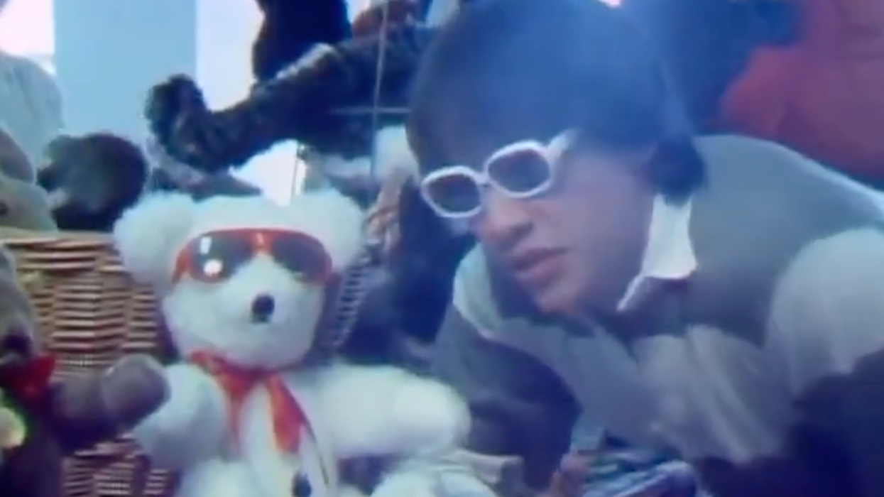 Young Keanu Reeves with a teddy bear.