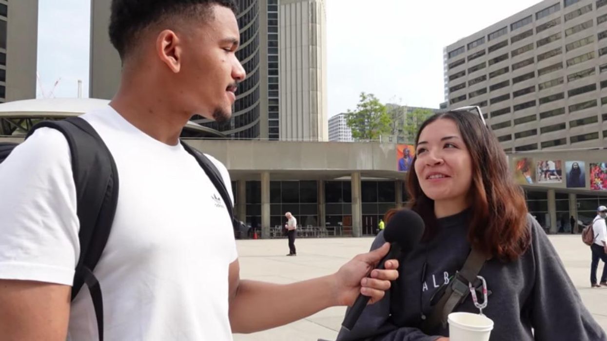 YouTuber Saye Pries talking to someone in the streets of Toronto.