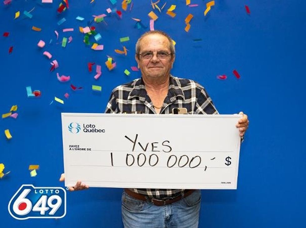 yves samson holding a $1 million lotto 6/49 cheque
